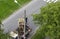 A worker in protective gear replaces the light bulbs in the lantern. An electrician repairing a street lamp, an electrician climbs