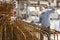 Worker in protective mask prepares metal rebar for loading onto truck