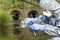 Worker in protective suit checks river water for pollution and radiation