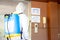 Worker in protective white jumpsuit and pumping spraying machine disinfected virus pandemic in the office