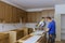 Worker protects himself from covid-19, man cut using circular saw rotating saw cutting wooden installation of in the kitchen of