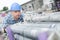 Worker pushing stack scaffolding tubes