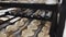 Worker puts tray of rolls with poppy seeds to bake closeup