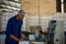 Worker putting olive in machine in factory