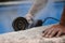 Worker with radial saw with dust on the air with blue background