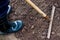 Worker is raking the black soil with rake in the vegetable garden