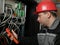 Worker in red helmet make electrical measurements