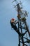 Worker in red helmet working on 5G antenna system