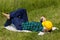 Worker relaxes lying on a meadow with a helmet and in working clothes, Concept, Work Life Balance, Balanced working and rest times