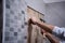 Worker remove demolish old tiles in a bathroom