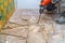 Worker remove, demolish old tiles a bathroom with jackhammer