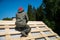 Worker on a renovation roof under construction, carpenter on the work