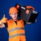 Worker, repairer, repairman, builder on confident face carries toolbox on shoulder. Man in helmet, hard hat holds