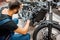 Worker repairing motorcycle engine at the workshop