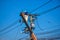 Worker repairing work on electric post power pole