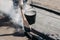 Worker repairs the roof with molten tar from a bucket with a broom