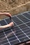 Worker on a roof installing solar panel