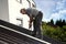 Worker roofer builder working on roof structure