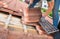 worker on the rooftop, replacing broken tiles with new shingles