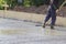 worker in rubber boots stands in uncluttered cement and leveling