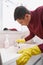 Worker in rubber gloves cleaning water tap