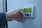 Worker’s hand touching control board of the electrolysis units set in the hall of the disinfecting water at the