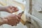 Worker`s hands are cutting a perforated aluminum corner.