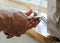 Worker`s hands are cutting a perforated aluminum corner.