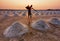 Worker in salt farm during sunset , Thailand