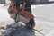 A worker saws a concrete block and builds a road.