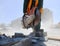 A worker saws a concrete block with a circular saw.