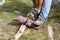 The worker saws the log with an electric saw.