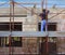 Worker on scaffold building masonry