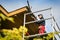 Worker on scaffolding renovating wooden roof structure