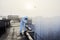 Worker scientist wearing protective coverall and gas mask doing ecological tests on the roof