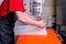 A worker seals the mold for pouring plastic. Manufacturing of plastic products. Medium business concept. Hands close-up