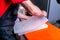 A worker seals the mold for pouring plastic. Manufacturing of plastic products. Medium business concept. Hands close-up