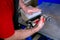 A worker seals the mold for pouring plastic. Manufacturing of plastic products. Medium business concept. Hands close-up