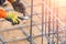 Worker Securing Steel Rebar Framing With Wire Plier Cutter Tool