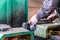 The worker sets the metal workpiece in a vice for processing on a CNC milling machine