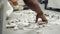 A worker shifts and removes the pieces floor tiles with his bare hands. Office renovation.Removing construction debris