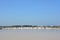 Worker shoveling salt at salt pan at Thailand