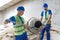 The worker shovels sand into the mixer stock image