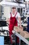 Worker showing thumbs up sign next to conveyor belt