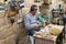 A worker sits and makes souvenirs for sale from an olive tree at a gift shop in Bethlehem in the Palestinian Authority, Israel