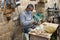 A worker sits and makes souvenirs for sale from an olive tree at a gift shop in Bethlehem in the Palestinian Authority, Israel