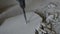 Worker smashes concrete floor with electric hammer drill