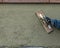 Worker Smoothing Cement with Wooden Float At Construction Site