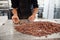 Worker sorting cocoa beans in an artisanal chocolate factory