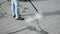 worker with special device and long metal hose cleaning the street by hot steam closeup, modern technology,